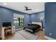 Stylish bedroom featuring blue walls, a ceiling fan, and a cozy atmosphere at 5237 Haverill Dr, Orlando, FL 32809