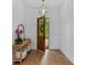Bright entryway with hardwood floors, console table, gold mirror, and statement light fixture at 5237 Haverill Dr, Orlando, FL 32809