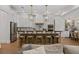 Spacious kitchen with white cabinets, pendant lighting, large island with seating and stainless steel appliances at 5237 Haverill Dr, Orlando, FL 32809