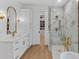 Elegant bathroom featuring double vanity, walk-in closet, and marble-tiled shower at 5237 Haverill Dr, Orlando, FL 32809
