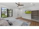 Bright main bedroom featuring a ceiling fan, wood floors and a view to the outside at 5237 Haverill Dr, Orlando, FL 32809