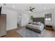 Bright main bedroom featuring a gray upholstered headboard and a ceiling fan at 5237 Haverill Dr, Orlando, FL 32809