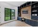 Stylish home office featuring custom built-ins, a large window and wood floors at 5237 Haverill Dr, Orlando, FL 32809