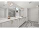 Bright bathroom featuring double vanity, quartz countertop, and glass-enclosed shower at 5700 Iron Brand Rd, St Cloud, FL 34771