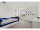 Bright bedroom with carpet, a blue toddler bed, and dinosaur-themed decor at 5700 Iron Brand Rd, St Cloud, FL 34771