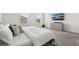 Comfortable bedroom with neutral colors, large windows, and a dresser with a television at 5700 Iron Brand Rd, St Cloud, FL 34771
