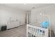 White bedroom with carpet, dresser, and crib at 5700 Iron Brand Rd, St Cloud, FL 34771