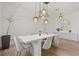 Elegant dining room featuring modern lighting, neutral tones, and wood floors at 5700 Iron Brand Rd, St Cloud, FL 34771