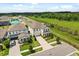 View of a two-story home with well-manicured landscaping and a welcoming front porch at 5700 Iron Brand Rd, St Cloud, FL 34771