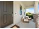 Inviting front porch featuring chairs with stone pillars, perfect for relaxing at 5700 Iron Brand Rd, St Cloud, FL 34771