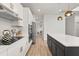 Bright, modern kitchen with white cabinets, stainless steel appliances, and a large island with pendant lighting at 5700 Iron Brand Rd, St Cloud, FL 34771