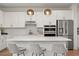 Stylish kitchen with white cabinetry, stainless steel appliances, and a spacious island perfect for entertaining at 5700 Iron Brand Rd, St Cloud, FL 34771