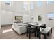 Spacious living room with high ceilings, modern furniture, and a sleek entertainment center at 5700 Iron Brand Rd, St Cloud, FL 34771