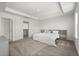 Serene bedroom with neutral decor, a tray ceiling, and a closet with plenty of storage space at 5700 Iron Brand Rd, St Cloud, FL 34771