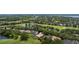 Aerial view of several homes nestled within a lush golf course community surrounded by trees and lakes at 5950 Blakeford Dr, Windermere, FL 34786