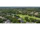 Aerial view of residences and a lush golf course community, complete with a tranquil pond at 5950 Blakeford Dr, Windermere, FL 34786