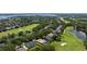 Aerial view showcases the property's location on a golf course, surrounded by lush landscaping at 5950 Blakeford Dr, Windermere, FL 34786