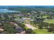 Stunning aerial view of community with lake, golf course, and lush landscaping at 5950 Blakeford Dr, Windermere, FL 34786