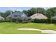 Expansive backyard featuring a sand trap, lush landscaping, and a screened-in lanai at 5950 Blakeford Dr, Windermere, FL 34786