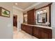 Luxurious bathroom with double vanities, granite countertops, custom cabinets, and access to a walk-in closet at 5950 Blakeford Dr, Windermere, FL 34786