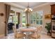 Bright dining area featuring shuttered windows and sliding glass doors leading to a covered outdoor seating area at 5950 Blakeford Dr, Windermere, FL 34786