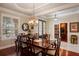 Formal dining room with hardwood floors, chandelier, and views to the front yard at 5950 Blakeford Dr, Windermere, FL 34786