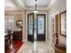 Elegant foyer with marble floors, decorative double doors, and natural light at 5950 Blakeford Dr, Windermere, FL 34786