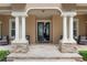 Inviting front entrance with stone pillars and a double door entry at 5950 Blakeford Dr, Windermere, FL 34786