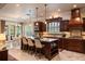 Bright kitchen featuring an island with seating, custom cabinetry, stainless appliances, and marble floors at 5950 Blakeford Dr, Windermere, FL 34786