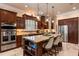 Gourmet kitchen with custom cabinets, granite countertops, stainless steel appliances, and a large center island at 5950 Blakeford Dr, Windermere, FL 34786