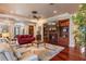 Cozy living room with a fireplace, built-in bookshelves, and hardwood flooring at 5950 Blakeford Dr, Windermere, FL 34786