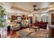 Open-concept living area with hardwood floors, a fireplace, and a seamless flow to the kitchen and dining spaces at 5950 Blakeford Dr, Windermere, FL 34786