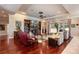 Cozy living room featuring a fireplace, built-in shelves, hardwood floors, and a comfortable seating area at 5950 Blakeford Dr, Windermere, FL 34786