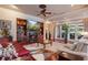 Spacious living room with hardwood floors, fireplace, built-in shelves, and sliding glass doors to the outside at 5950 Blakeford Dr, Windermere, FL 34786