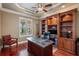 Spacious home office with custom built-in shelving and a large window at 5950 Blakeford Dr, Windermere, FL 34786