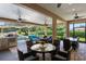 A luxurious outdoor patio with ample seating, dining and outdoor kitchen and waterfall pool feature at 5950 Blakeford Dr, Windermere, FL 34786
