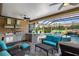 A covered patio with a waterfall pool feature, an outdoor kitchen and ample seating at 5950 Blakeford Dr, Windermere, FL 34786