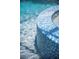 The swimming pool has a curved mosaic tile border and crystal clear water at 5950 Blakeford Dr, Windermere, FL 34786