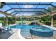 Stunning pool and spa with a waterfall feature, covered by a screen enclosure, offer luxurious outdoor living at 5950 Blakeford Dr, Windermere, FL 34786