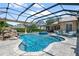 Inviting screened pool with spa and rock feature offers a private backyard oasis for relaxation and fun at 5950 Blakeford Dr, Windermere, FL 34786