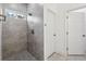 Modern bathroom features tiled walk-in shower and neutral tile floors at 6062 Sw 154Th Pl, Ocala, FL 34473