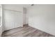 Bedroom features a double closet, wood-look floors and neutral walls at 6062 Sw 154Th Pl, Ocala, FL 34473