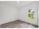 Bright bedroom features wood-look floors, a window and neutral decor at 6062 Sw 154Th Pl, Ocala, FL 34473