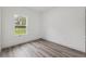 Well-lit bedroom boasts wood-look floors and a bright window view at 6062 Sw 154Th Pl, Ocala, FL 34473