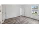 Bedroom boasts wood-look floors and a view of the neighborhood at 6062 Sw 154Th Pl, Ocala, FL 34473