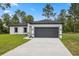 Charming single-story home with a well-maintained lawn and a two-car garage at 6062 Sw 154Th Pl, Ocala, FL 34473