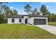 Charming single-story home with a well-maintained lawn and a two-car garage at 6062 Sw 154Th Pl, Ocala, FL 34473