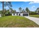 Charming single-story home with a well-maintained lawn and a two-car garage at 6062 Sw 154Th Pl, Ocala, FL 34473
