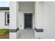 A covered front porch with gray trim accents at 6062 Sw 154Th Pl, Ocala, FL 34473