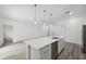 Modern kitchen features a large island with sink and stainless steel appliances at 6062 Sw 154Th Pl, Ocala, FL 34473